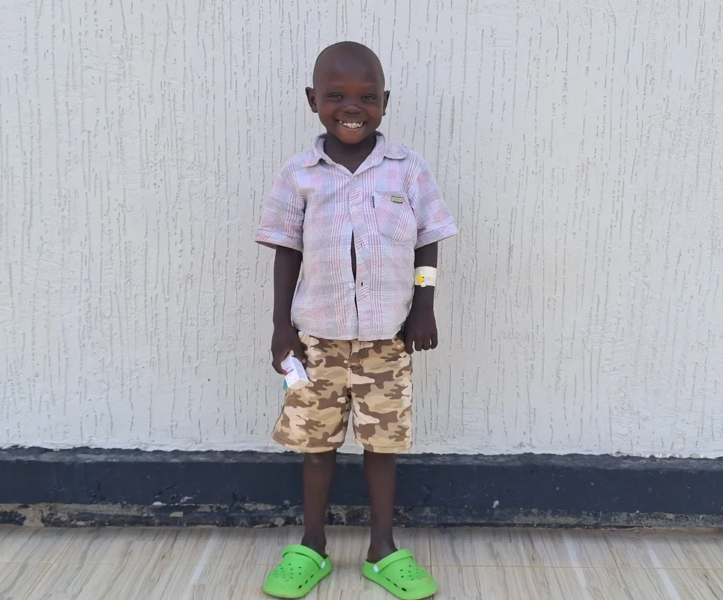 6-year-old Ocira Edmond posing at St. John XXIII Hospital Aber following treatment for sickle cell disease.